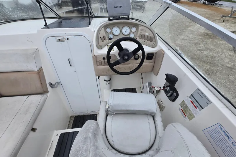 Slide: The Image of 1996 Wellcraft 26 Exel SE boat cockpit with steering wheel and control panel. - 6