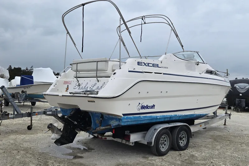 Slide: The Image of 1996 Wellcraft 26 Exel SE boat on trailer, parked outdoors. - 8