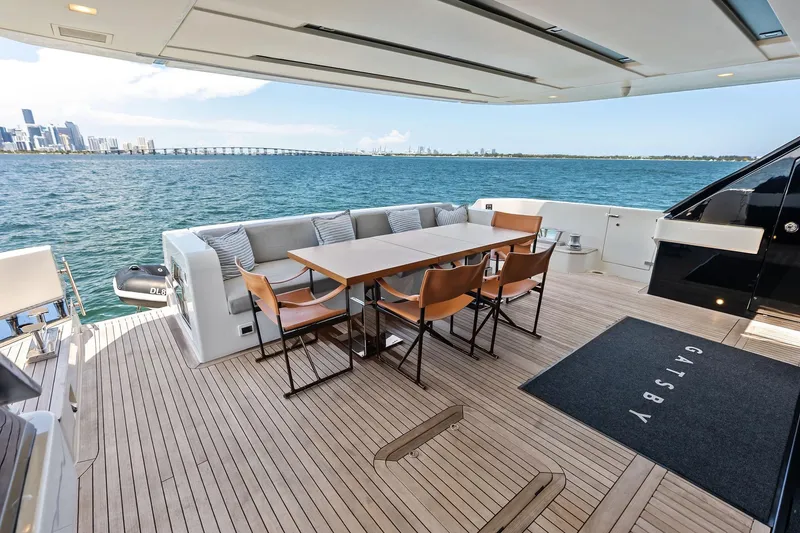 Slide: The Image of Luxury Sanlorenzo SL96A yacht deck with dining area, overlooking ocean and city skyline, 2021 model. - 20