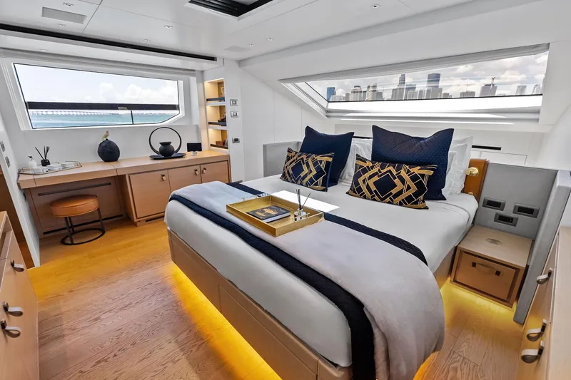 Slide: The Image of Luxurious 2021 Sanlorenzo SL96A yacht bedroom with modern decor and city skyline view. - 31