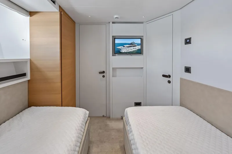 Slide: The Image of Interior of 2021 Sanlorenzo SL96A yacht cabin with twin beds and wall-mounted TV. - 46