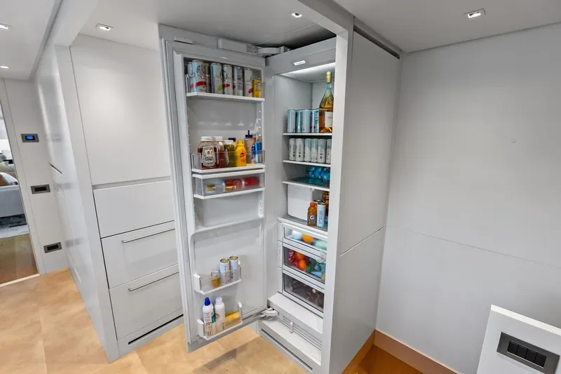 Slide: The Image of Modern kitchen fridge on Sanlorenzo SL96A yacht, stocked with beverages and condiments. - 56