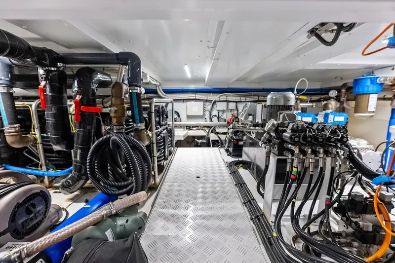 Slide: The Image of Engine room of 2021 Sanlorenzo SL96A yacht, showcasing complex machinery and piping systems. - 60