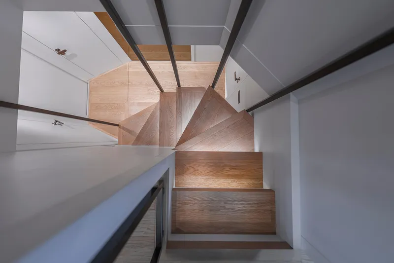 Slide: The Image of Wooden spiral staircase inside 2021 Sanlorenzo SL96A yacht, showcasing modern design. - 9