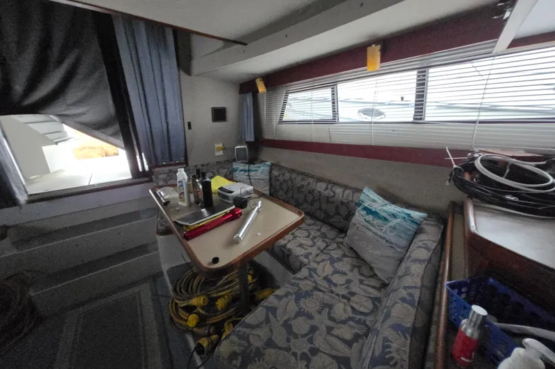 Slide: The Image of Interior of 1987 Carver 32 Mariner with seating, table, and nautical decor. - 10