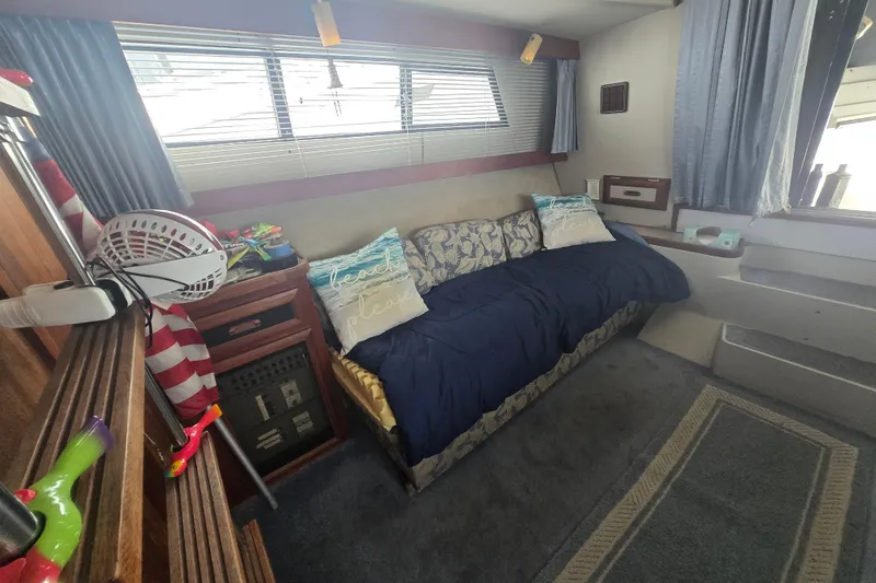 Slide: The Image of Interior of 1987 Carver 32 Mariner with cozy seating and nautical decor. - 11