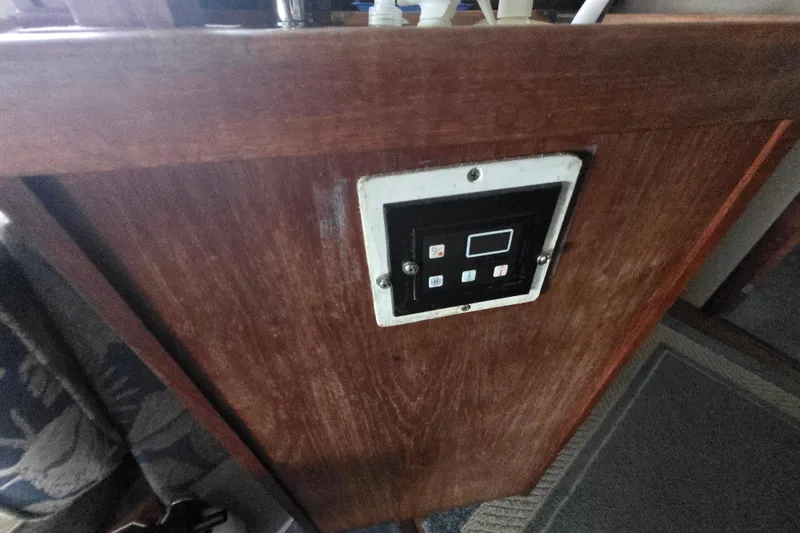 Slide: The Image of Control panel on 1987 Carver 32 Mariner boat, mounted on wooden surface. - 16
