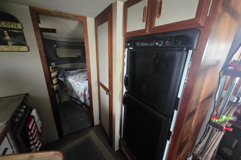 Slide: The Image of Interior of 1987 Carver 32 Mariner with cozy cabin and kitchenette. - 17