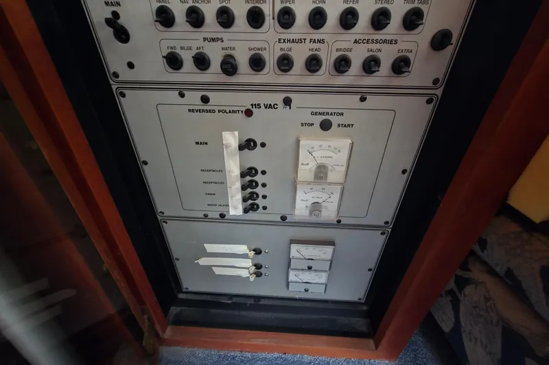 Slide: The Image of Electrical control panel on a 1987 Carver 32 Mariner boat, featuring switches and gauges. - 19