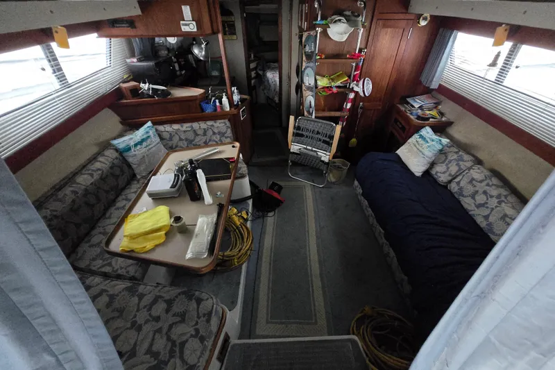 Slide: The Image of Interior of 1987 Carver 32 Mariner boat with cozy seating and nautical decor. - 2