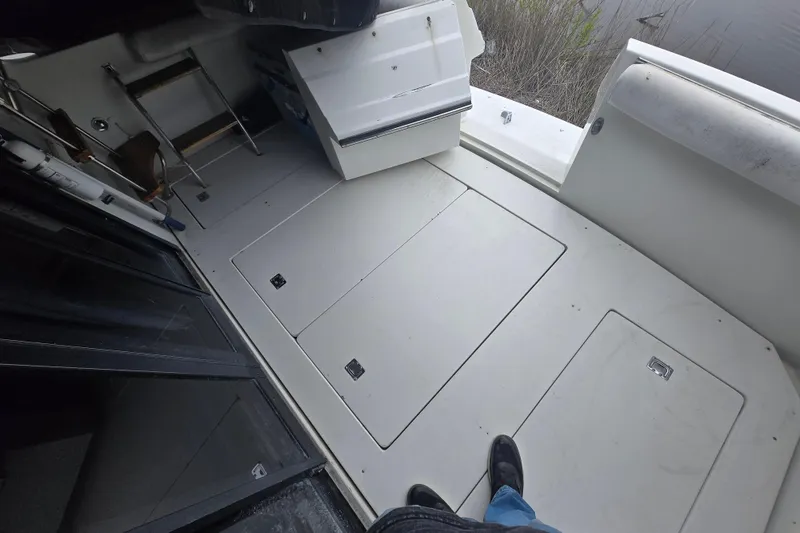 Slide: The Image of 1987 Carver 32 Mariner boat deck with storage compartments and ladder. - 22