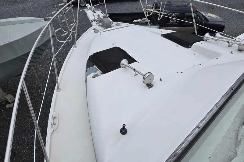 Slide: The Image of 1987 Carver 32 Mariner boat deck with railings and equipment, parked on gravel. - 5