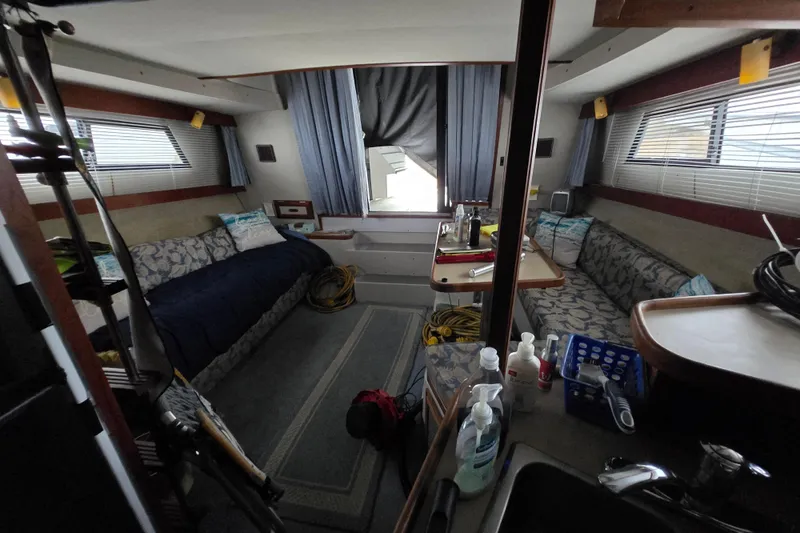 Slide: The Image of Interior of a 1987 Carver 32 Mariner boat with cozy seating and nautical decor. - 7
