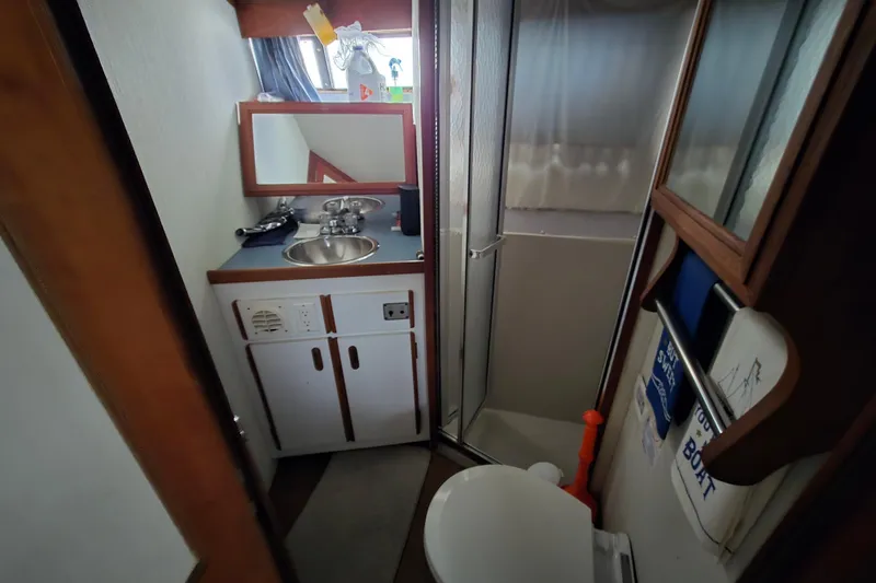 Slide: The Image of Bathroom interior of 1987 Carver 32 Mariner boat with sink, mirror, and shower. - 8