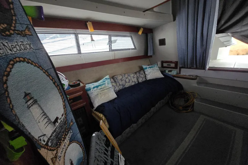 Slide: The Image of Interior of 1987 Carver 32 Mariner boat with cozy seating and nautical decor. - 9