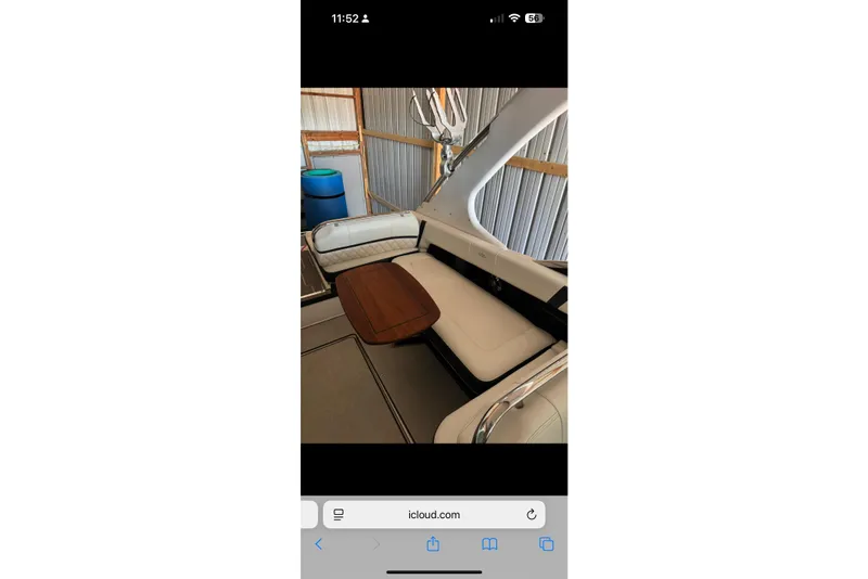 Slide: The Image of Interior of a 2020 Regal 2800 Bowrider boat with cushioned seating and wooden table. - 10