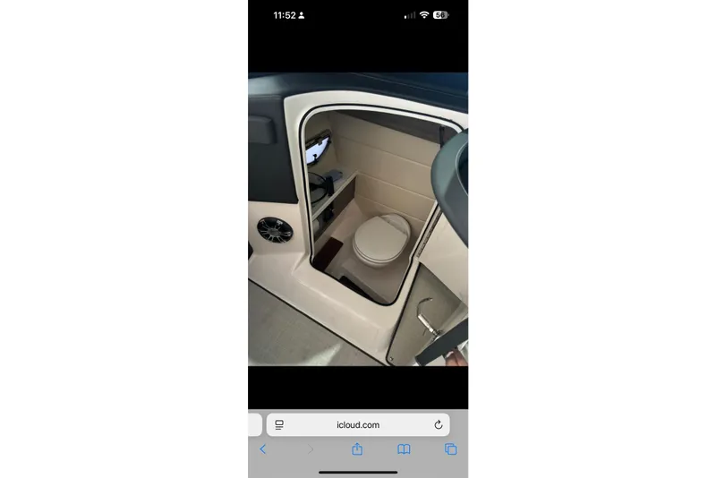 Slide: The Image of Interior of 2020 Regal 2800 Bowrider boat featuring a compact marine toilet. - 11