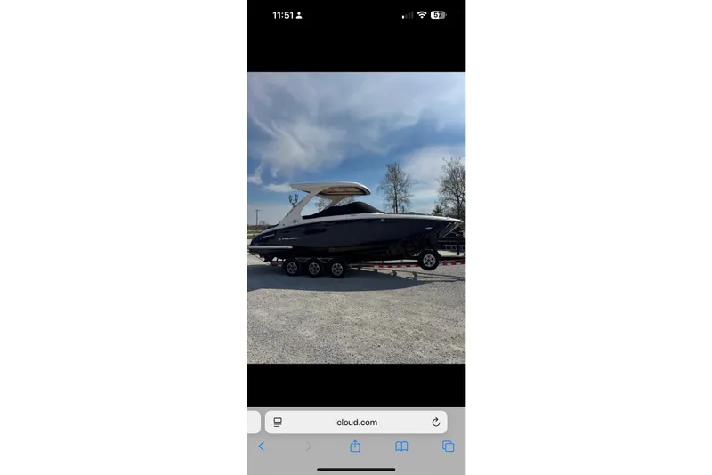 Slide: The Image of 2020 Regal 2800 Bowrider boat on trailer under clear sky. - 3