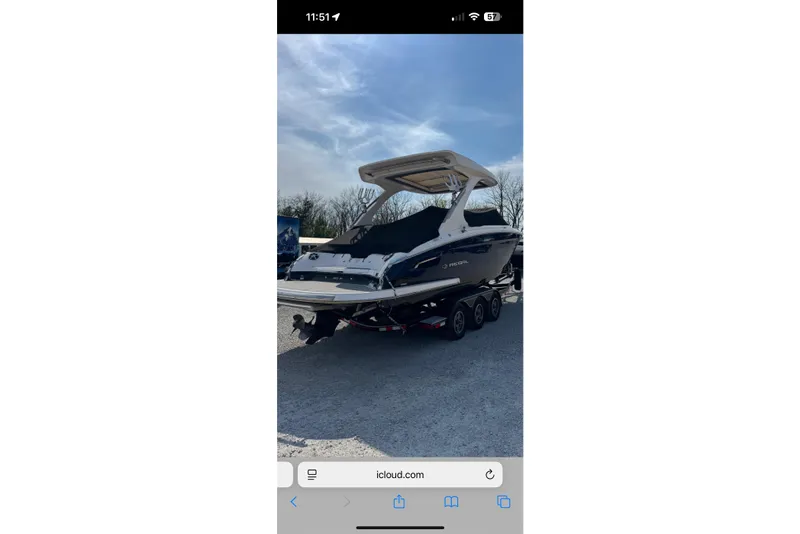 Slide: The Image of 2020 Regal 2800 Bowrider boat on trailer under clear sky. - 4
