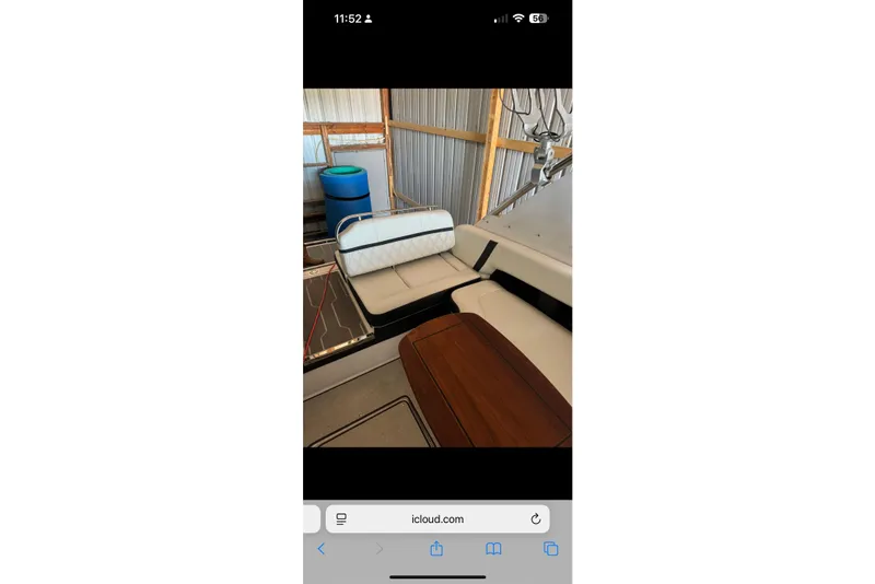Slide: The Image of 2020 Regal 2800 Bowrider interior with seating and wooden table in a storage area. - 7