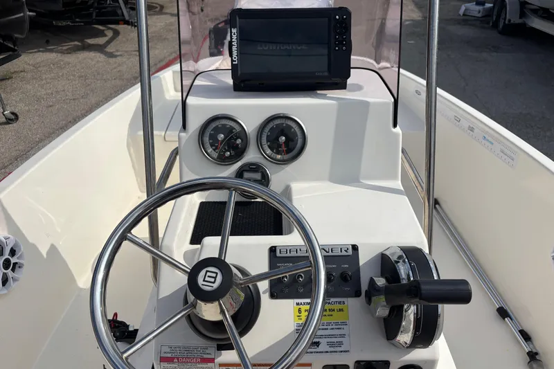 Slide: The Image of 2019 Bayliner Element F18 boat dashboard with steering wheel and navigation system. - 18