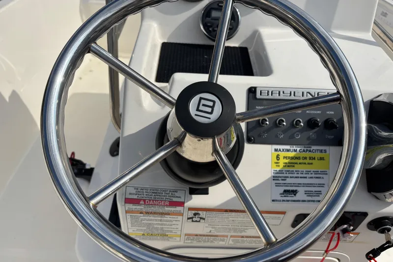 Slide: The Image of Steering wheel and controls of 2019 Bayliner Element F18 boat cockpit. - 20