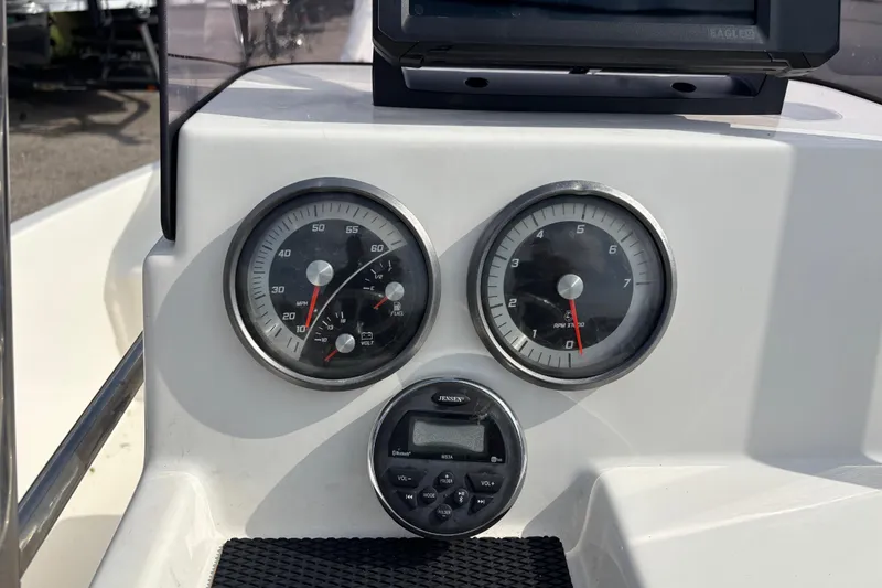 Slide: The Image of Dashboard of a 2019 Bayliner Element F18 boat with gauges and controls. - 21