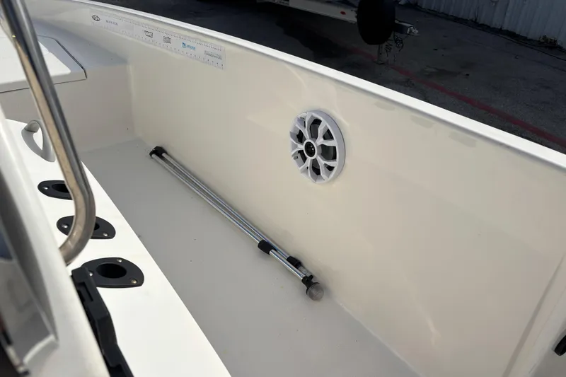 Slide: The Image of 2019 Bayliner Element F18 boat interior with speaker and rod holders. - 22