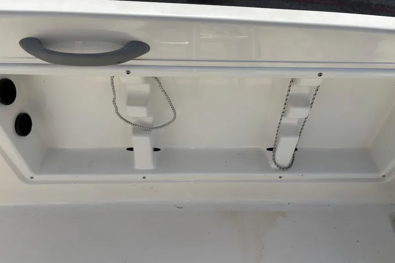 Slide: The Image of 2019 Bayliner Element F18 boat interior detail with storage compartments and handle. - 23
