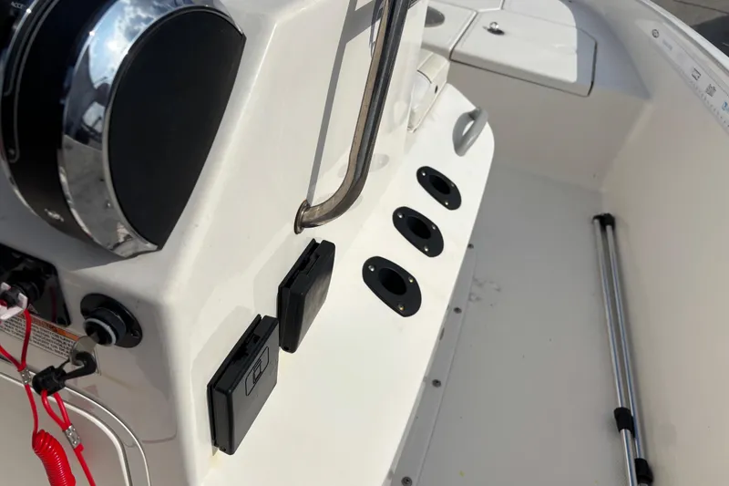 Slide: The Image of 2019 Bayliner Element F18 boat console with controls and rod holders. - 28