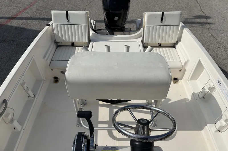 Slide: The Image of 2019 Bayliner Element F18 boat interior with steering wheel and seating arrangement. - 32