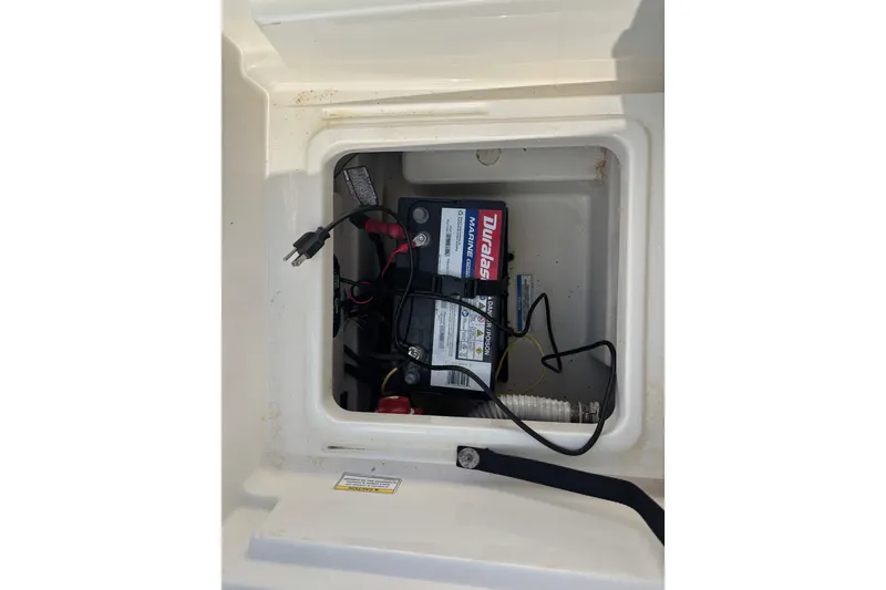 Slide: The Image of Battery compartment of 2019 Bayliner Element F18 boat with Duralast marine battery. - 36