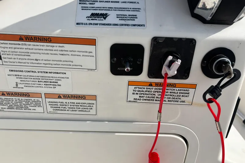 Slide: The Image of Control panel of a 2019 Bayliner Element F18 with safety warnings and ignition switches. - 37