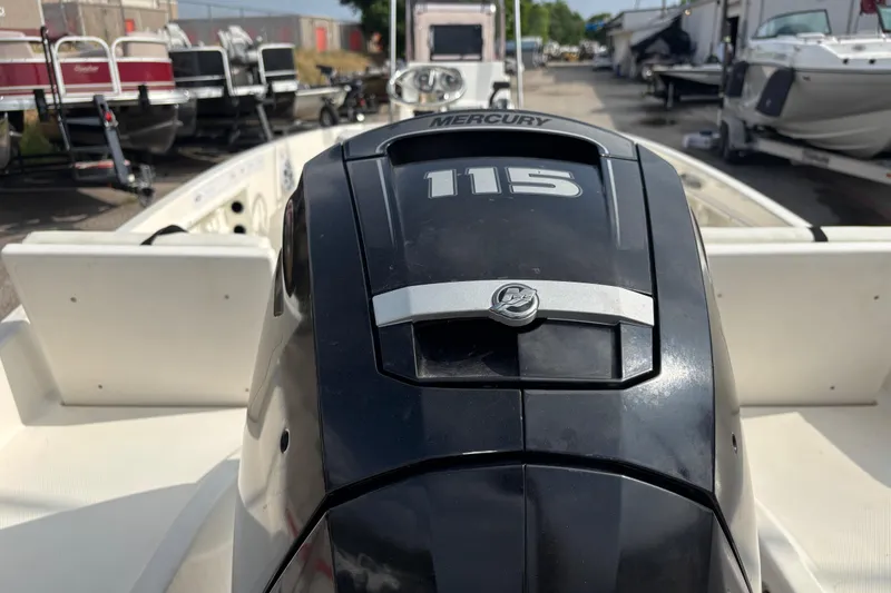 Slide: The Image of 2019 Bayliner Element F18 with Mercury 115 engine, displayed in a boat dealership. - 39