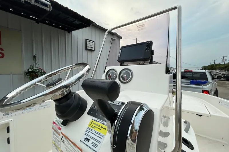 Slide: The Image of 2019 Bayliner Element F18 boat with Mercury engine on trailer, parked outdoors. - 4