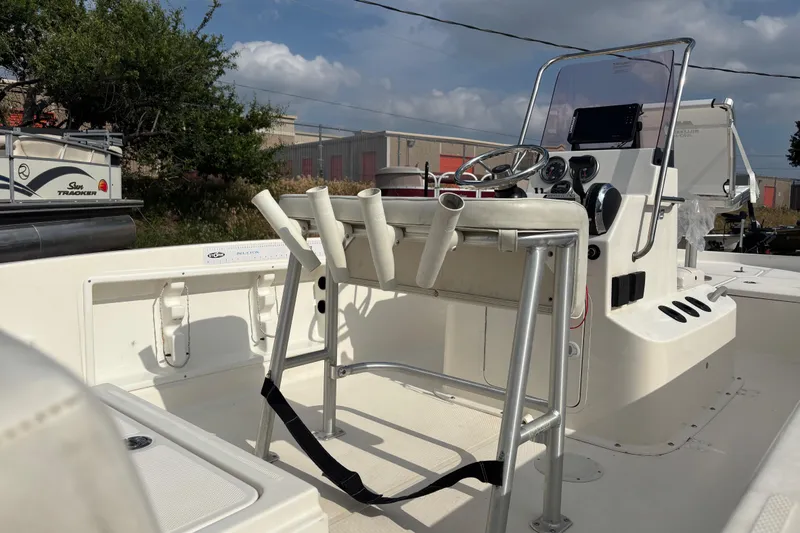 Slide: The Image of 2019 Bayliner Element F18 boat interior with steering console and rod holders. - 43