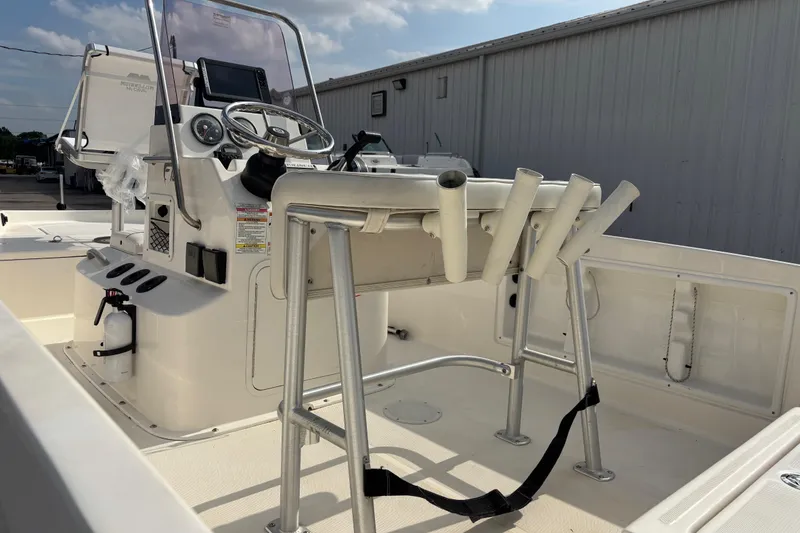 Slide: The Image of 2019 Bayliner Element F18 boat interior with steering console and rod holders. - 44