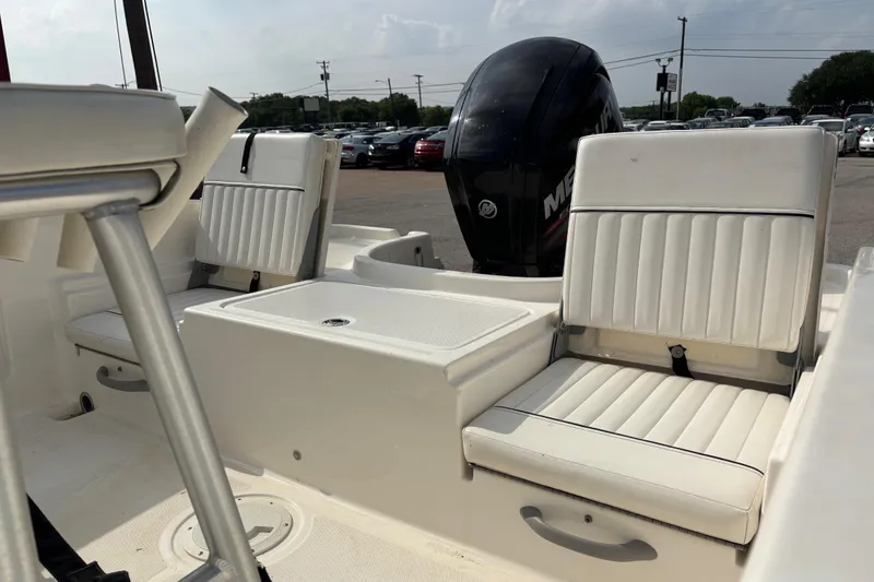 Slide: The Image of 2019 Bayliner Element F18 boat interior with white seating and Mercury outboard motor. - 45