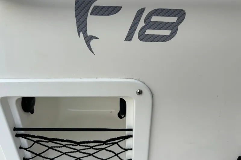 Slide: The Image of 2019 Bayliner Element F18 boat on trailer, parked outdoors under a clear sky. - 5