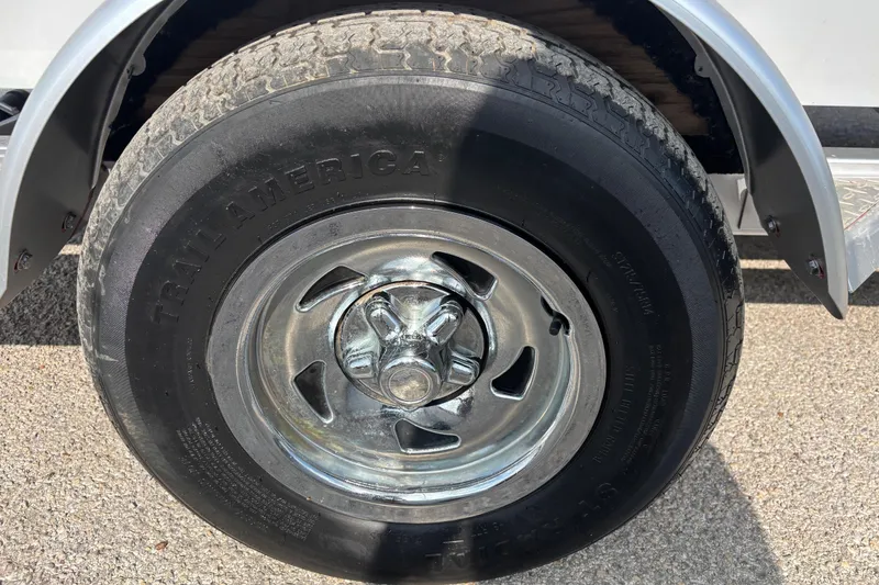 Slide: The Image of Close-up of a 2019 Bayliner Element F18 trailer wheel with Trail America tire. - 55