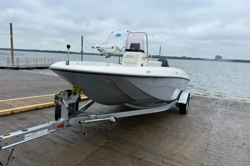 Slide: The Image of 2019 Bayliner Element F18 boat on trailer by a lake under cloudy skies. - 58