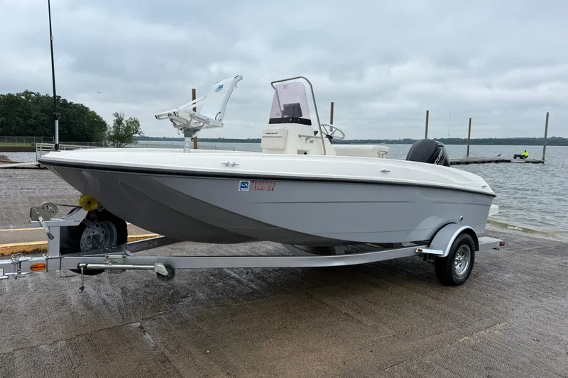 Slide: The Image of 2019 Bayliner Element F18 boat on trailer by a lake under cloudy skies. - 59