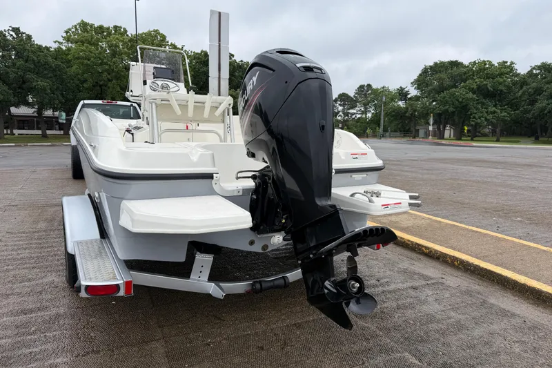 Slide: The Image of 2019 Bayliner Element F18 boat on trailer with outboard motor in parking lot. - 61