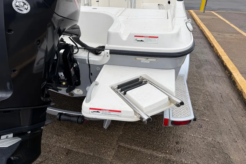 Slide: The Image of 2019 Bayliner Element F18 boat with foldable swim ladder and outboard motor. - 63