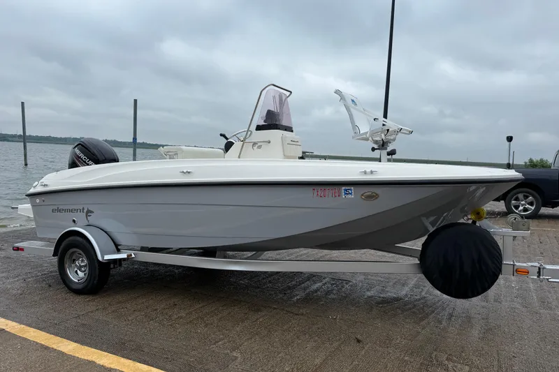 Slide: The Image of 2019 Bayliner Element F18 boat on trailer by the water. - 66