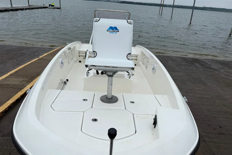 Slide: The Image of 2019 Bayliner Element F18 boat at dock, featuring a central seat and spacious deck. - 68