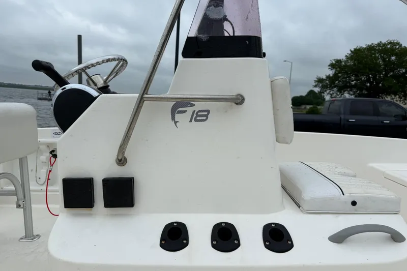 Slide: The Image of 2019 Bayliner Element F18 boat console with steering wheel and controls. - 69