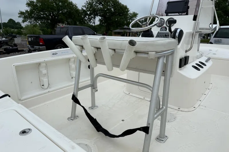 Slide: The Image of 2019 Bayliner Element F18 boat interior with steering console and rod holders. - 71
