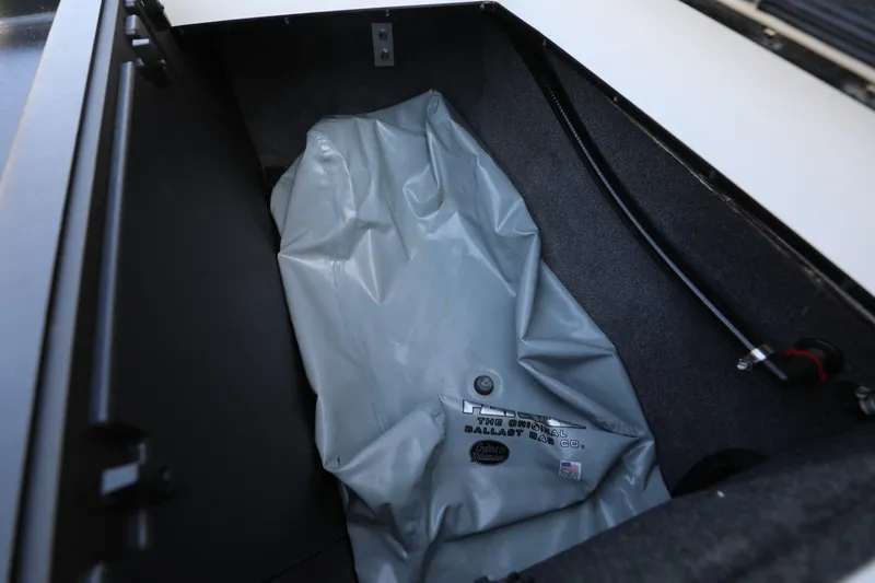 Slide: The Image of 2019 Axis T22 boat ballast compartment with gray ballast bag and hose. - 15