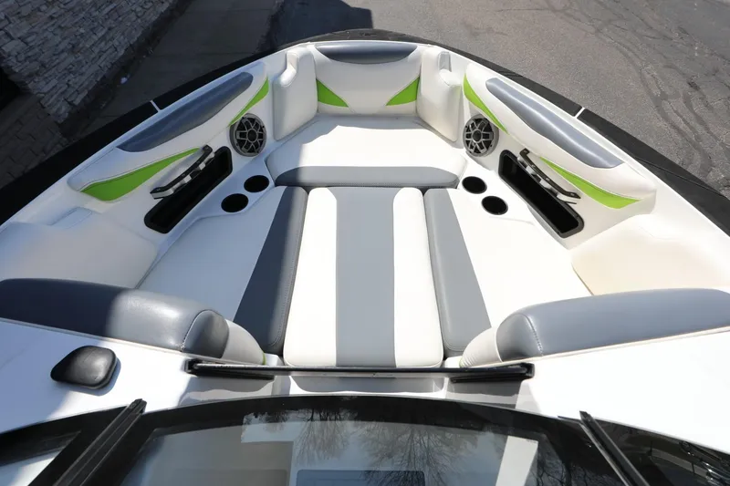 Slide: The Image of 2019 Axis T22 boat interior with gray and green accents, featuring speakers and cup holders. - 5